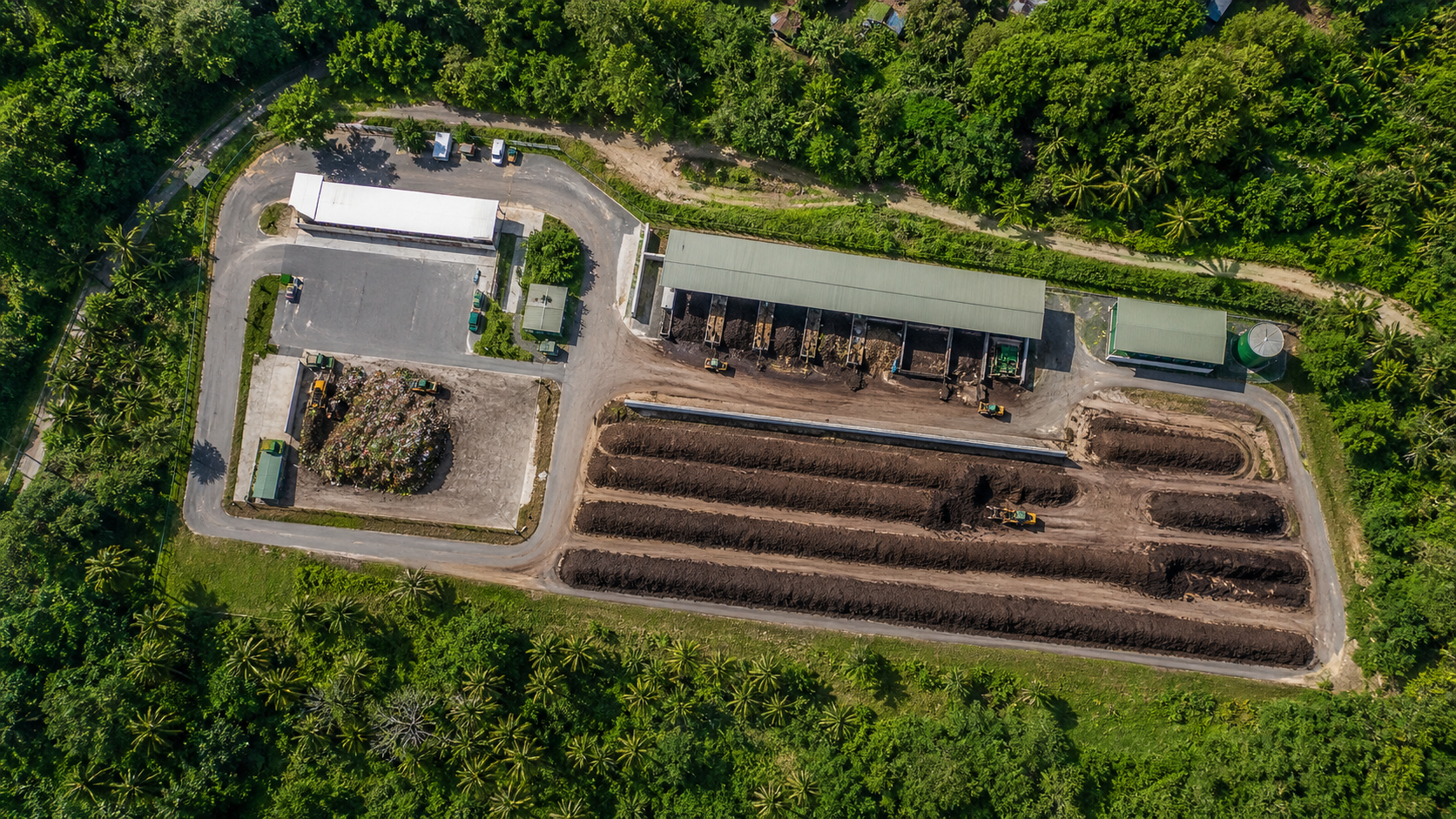 Bird's-eye view of a composting facility surrounded by tropical greenery